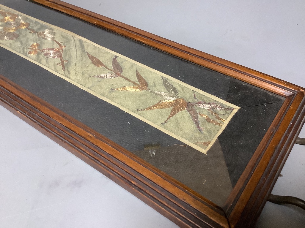 A Chinese gold couch work silk panel, mounted in a tray 62cm